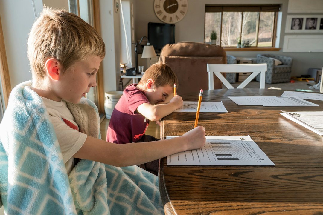 Teen homework procrastination: teenager reading and working at a desk